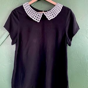 Black blouse with white detailed neckline
